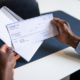 Man holding paycheck - can a personal injury settlement be garnished?