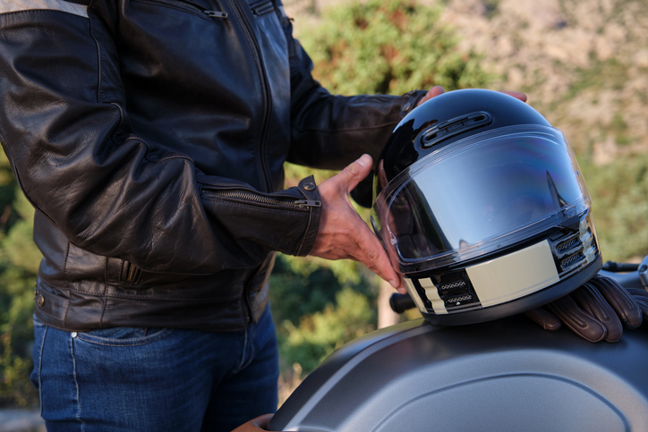man putting helmet on motorcycle - atlanta motorcycle accident lawyer
