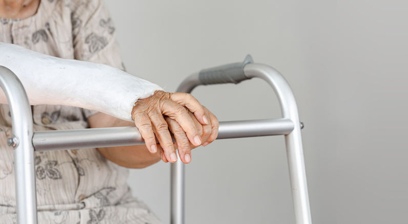 injured elderly patient with a walker and a cast on her arm - does Medicare cover injuries from a car accident?