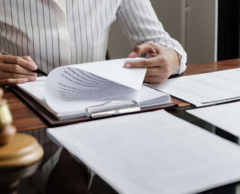Lawyer reading documents - How do trial lawyers compare to settlement lawyers in personal injury?