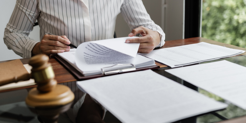Lawyer reading documents - How do trial lawyers compare to settlement lawyers in personal injury?